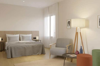 Chambre élégante et lumineuse de l’hôtel Room Mate Laura à Madrid, au design minimaliste et tons naturels.